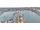 Aerial view of waterfront homes with lush landscaping and a view of the ocean at 16134 4Th E St, Redington Beach, FL 33708