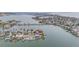 Lovely aerial view of a waterfront home with a pool and boat dock at 16134 4Th E St, Redington Beach, FL 33708