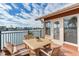 Cozy balcony offers serene water views and a table set at 16134 4Th E St, Redington Beach, FL 33708