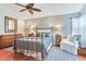 Bright bedroom offers a ceiling fan, wood floors, queen bed, and decor, creating a cozy and inviting space at 16134 4Th E St, Redington Beach, FL 33708