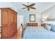 Relaxing bedroom features a ceiling fan, an armoire, and bed with accent pillows, creating a soothing atmosphere at 16134 4Th E St, Redington Beach, FL 33708