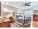 Comfortable bedroom features natural light, ceiling fan and classic wrought iron bed frame, offering a relaxing space at 16134 4Th E St, Redington Beach, FL 33708