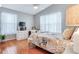 Bedroom featuring wood floors, ceiling fan, natural light, and a television above a built-in dresser at 16134 4Th E St, Redington Beach, FL 33708