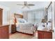 Bedroom with light walls, wood furnishings, and a bed with floral and light blue bedding at 16134 4Th E St, Redington Beach, FL 33708