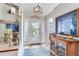 Elegant foyer with a decorative mirror and an ornate front door with a front view at 16134 4Th E St, Redington Beach, FL 33708