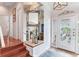 Elegant foyer with a decorative mirror and an ornate front door at 16134 4Th E St, Redington Beach, FL 33708