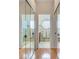Mirrored closet doors provide an entryway to the bathroom with double vanities and shower with round windows at 16134 4Th E St, Redington Beach, FL 33708