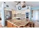 Spacious kitchen features stainless appliances, custom cabinetry, and a granite island with breakfast bar at 16134 4Th E St, Redington Beach, FL 33708