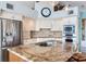 Bright kitchen features stainless appliances, custom cabinetry, and a large granite island at 16134 4Th E St, Redington Beach, FL 33708