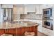 Bright kitchen boasts custom cabinetry, stainless appliances, and a center island with seating at 16134 4Th E St, Redington Beach, FL 33708
