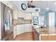 Bright kitchen featuring white cabinets, stainless appliances, and a granite island with sink at 16134 4Th E St, Redington Beach, FL 33708