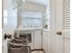 Bright laundry room featuring a washer, dryer, shelving, and storage cabinet at 16134 4Th E St, Redington Beach, FL 33708