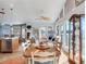 Bright living area features vaulted ceilings, large windows, and access to outdoor deck at 16134 4Th E St, Redington Beach, FL 33708
