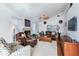 Comfortable living room featuring a fireplace, ceiling fan, and lots of natural light at 16134 4Th E St, Redington Beach, FL 33708