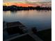Picturesque waterfront view featuring a private dock and vibrant sunset, ideal for serene living at 16134 4Th E St, Redington Beach, FL 33708