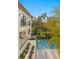 Beautiful backyard with a refreshing pool, tropical plants, and a view of the modern home's balconies at 337 Coffee Pot Ne Dr, St Petersburg, FL 33704