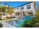 Gorgeous backyard with a modern pool, beautiful landscaping, and outdoor seating area at 337 Coffee Pot Ne Dr, St Petersburg, FL 33704