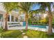 Beautiful backyard featuring a modern pool, stylish landscaping, and a covered patio at 337 Coffee Pot Ne Dr, St Petersburg, FL 33704