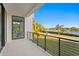 A spacious balcony with black metal railings has views of water, the waterfront and lush landscaping at 337 Coffee Pot Ne Dr, St Petersburg, FL 33704