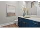 Powder room with custom vanity, vessel sink, modern lighting, and elegant finishes at 337 Coffee Pot Ne Dr, St Petersburg, FL 33704