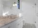 Modern bathroom featuring a marble countertop, sleek fixtures, and a glass shower at 337 Coffee Pot Ne Dr, St Petersburg, FL 33704