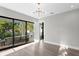 Bedroom featuring light wood floors, ensuite bathroom, and private balcony with views of the outdoors at 337 Coffee Pot Ne Dr, St Petersburg, FL 33704