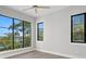 Bedroom with large windows, hardwood floors, and picturesque lake views at 337 Coffee Pot Ne Dr, St Petersburg, FL 33704