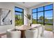 Bright dining room with water views, modern lighting, and seating for eight at 337 Coffee Pot Ne Dr, St Petersburg, FL 33704