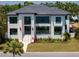 Elegant modern home with large windows, lush landscaping, and a well-manicured lawn at 337 Coffee Pot Ne Dr, St Petersburg, FL 33704