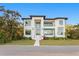 Striking modern home with a manicured lawn, a light-colored walkway, and a two-story facade with large windows at 337 Coffee Pot Ne Dr, St Petersburg, FL 33704