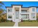 Stunning modern home with expansive windows, lush landscaping, and a well-manicured lawn at 337 Coffee Pot Ne Dr, St Petersburg, FL 33704
