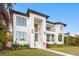Striking modern home with a manicured lawn, palm trees and clean, contemporary lines at 337 Coffee Pot Ne Dr, St Petersburg, FL 33704
