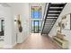 Inviting foyer with soaring ceilings, modern staircase, and expansive windows overlooking water views at 337 Coffee Pot Ne Dr, St Petersburg, FL 33704