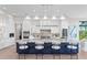 Modern kitchen with large island, stylish seating, high-end appliances, and contemporary finishes at 337 Coffee Pot Ne Dr, St Petersburg, FL 33704