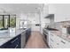 Elegant kitchen featuring marble countertops, stainless steel appliances, and custom cabinetry at 337 Coffee Pot Ne Dr, St Petersburg, FL 33704