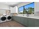 The laundry room features side by side washer and dryer, a large window, and plenty of storage at 337 Coffee Pot Ne Dr, St Petersburg, FL 33704