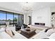 Spacious living room with large windows, fireplace, stylish seating, and a view of the waterfront at 337 Coffee Pot Ne Dr, St Petersburg, FL 33704