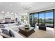 Bright living room with waterfront view, modern chandelier, comfortable seating, and open access to the kitchen at 337 Coffee Pot Ne Dr, St Petersburg, FL 33704