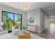 Living room showcasing modern lighting, hardwood floors, and a view to the exterior at 337 Coffee Pot Ne Dr, St Petersburg, FL 33704
