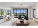 Elegant living room featuring water views from the large windows, modern lighting, and stylish decor at 337 Coffee Pot Ne Dr, St Petersburg, FL 33704