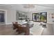 Bright, modern living room with white sofa, stylish chairs, and sliding doors to the outdoor space at 337 Coffee Pot Ne Dr, St Petersburg, FL 33704