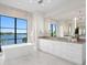 A primary bathroom showcasing tub with a view and dual sink vanity at 337 Coffee Pot Ne Dr, St Petersburg, FL 33704