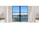 A soaking tub with a water view between two vanities in this primary bathroom at 337 Coffee Pot Ne Dr, St Petersburg, FL 33704