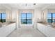 Luxury main bathroom featuring double vanities, a soaking tub, and waterfront views at 337 Coffee Pot Ne Dr, St Petersburg, FL 33704