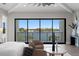 Modern main bedroom with floor-to-ceiling windows offering stunning water views and stylish decor at 337 Coffee Pot Ne Dr, St Petersburg, FL 33704