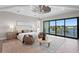 An airy main bedroom features a lake view, sitting area, and modern ceiling fan at 337 Coffee Pot Ne Dr, St Petersburg, FL 33704