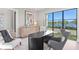 Bright home office featuring modern decor, large windows overlooking waterfront views, and stylish furnishings at 337 Coffee Pot Ne Dr, St Petersburg, FL 33704
