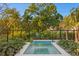 A stunning pool is framed by lush landscaping, creating a serene and private backyard retreat at 337 Coffee Pot Ne Dr, St Petersburg, FL 33704