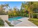 Private backyard pool with lush tropical landscaping and a serene setting at 337 Coffee Pot Ne Dr, St Petersburg, FL 33704