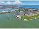 Stunning aerial view of a coastal community with waterfront homes, lush greenery, and recreational amenities under a bright sky at 343 Rex Pl # F, Madeira Beach, FL 33708